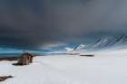A log cabin on the snow covered beach at Mushamna-Spitsbergen Island-Svalbard-Norway Art Print